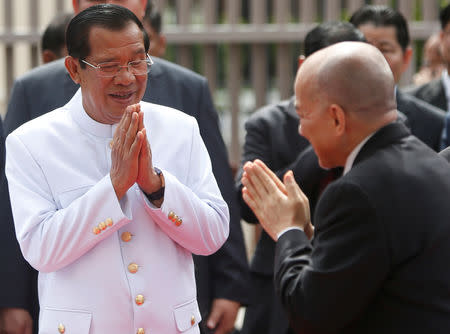 Cambodia's King Norodom Sihamoni (R) greets Cambodia's Prime Minister Hun Sen as he leaves after attending the first plenary parliament session at the National Assembly in Phnom Penh, Cambodia September 5, 2018. REUTERS/Samrang Pring