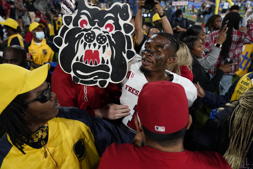 Fresno State wide receiver Keric Wheatfall holds a cutout of the school's mascot after a win over UCLA in an NCAA college football game Sunday, Sept. 19, 2021, in Pasadena, Calif. (AP Photo/Marcio Jose Sanchez)