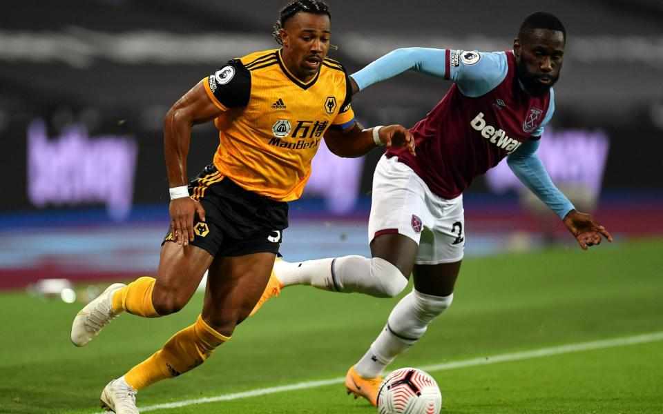 Adama Traore (left) and West Ham United's Arthur Masuaku battle for the ball during the Premier League match at the London Stadium - PA