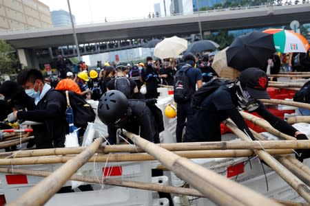 Demonstrators build barricades during a protest in Hong Kong