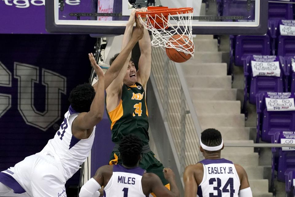 North Dakota State forward Rocky Kreuser (34) dunks the ball after getting through TCU defenders Kevin Samuel, left, Mike Miles (1) and Kevin Easley in the second half of an NCAA college basketball game in Fort Worth, Texas, Tuesday, Dec. 22, 2020. (AP Photo/Tony Gutierrez)