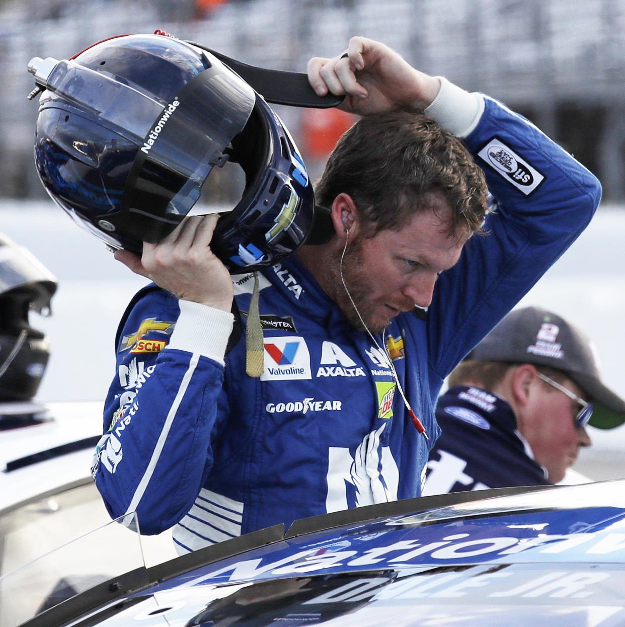 Dale Earnhardt Jr. takes off his helmet after qualifying for the NASCAR Cup Series 300 auto race at New Hampshire Motor Speedway in Loudon, N.H., Friday, Sept. 22, 2017. (AP Photo/Charles Krupa)