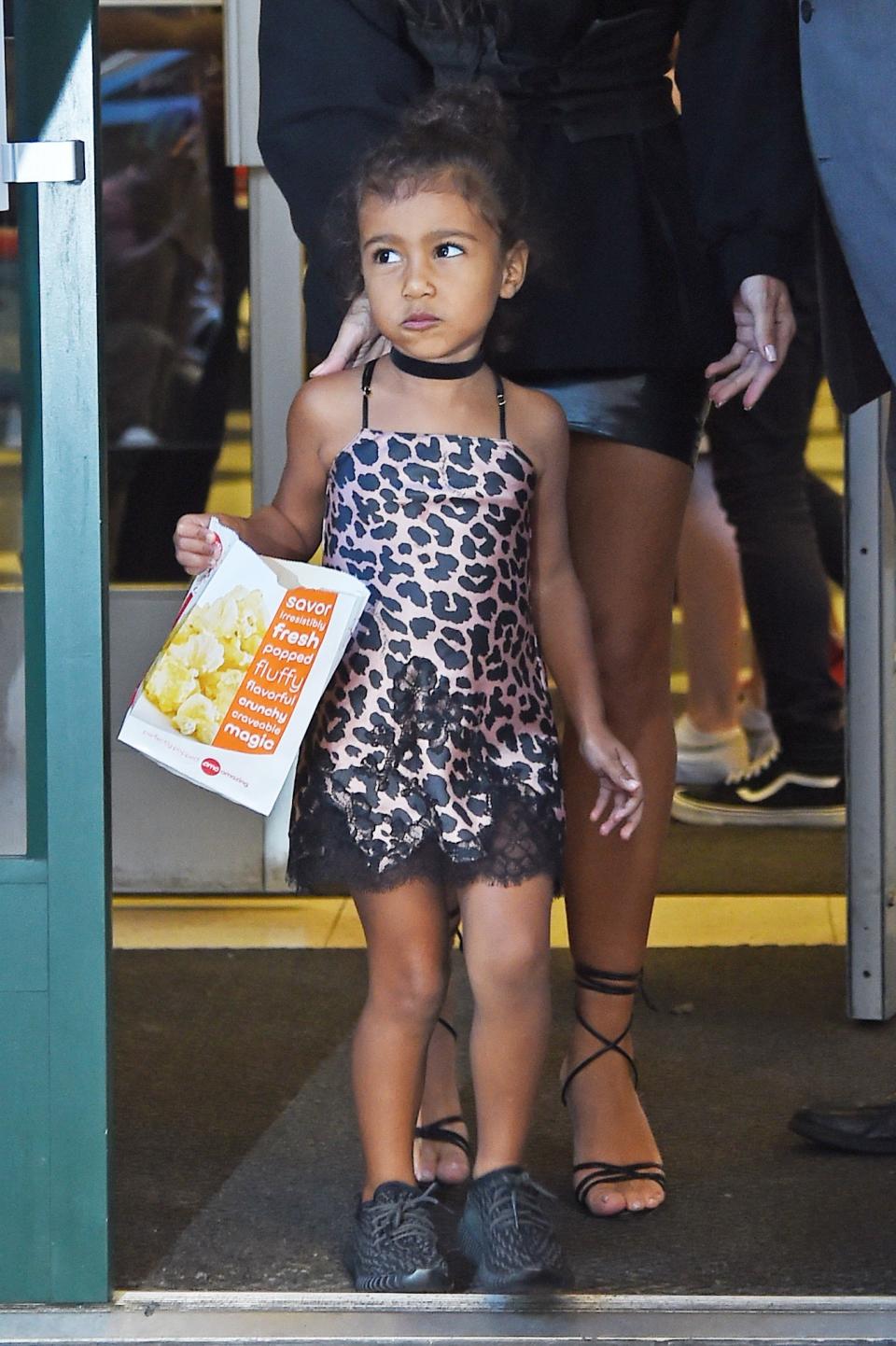 <p>Very ’90’s chic, with her cheetah print slip dress, velvet choker, and Yeezys from her dad’s line. (Photo: Backgrid) </p>