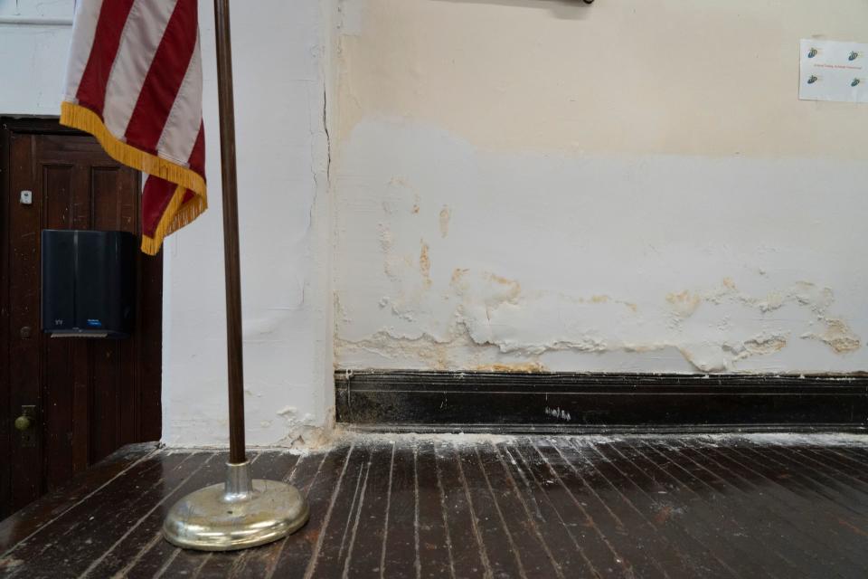 The paint is peeling from the walls in the auditorium, which also serves as the lunch room at Paterson's School 10.