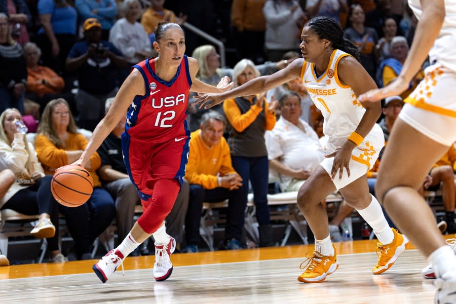 Team USA guard Diana Taurasi (12) drives past Tennessee guard Sara Puckett (1) during the second half of an NCAA college basketball exhibition game, Sunday, Nov. 5, 2023, in Knoxville, Tenn. (AP Photo/Wade Payne)