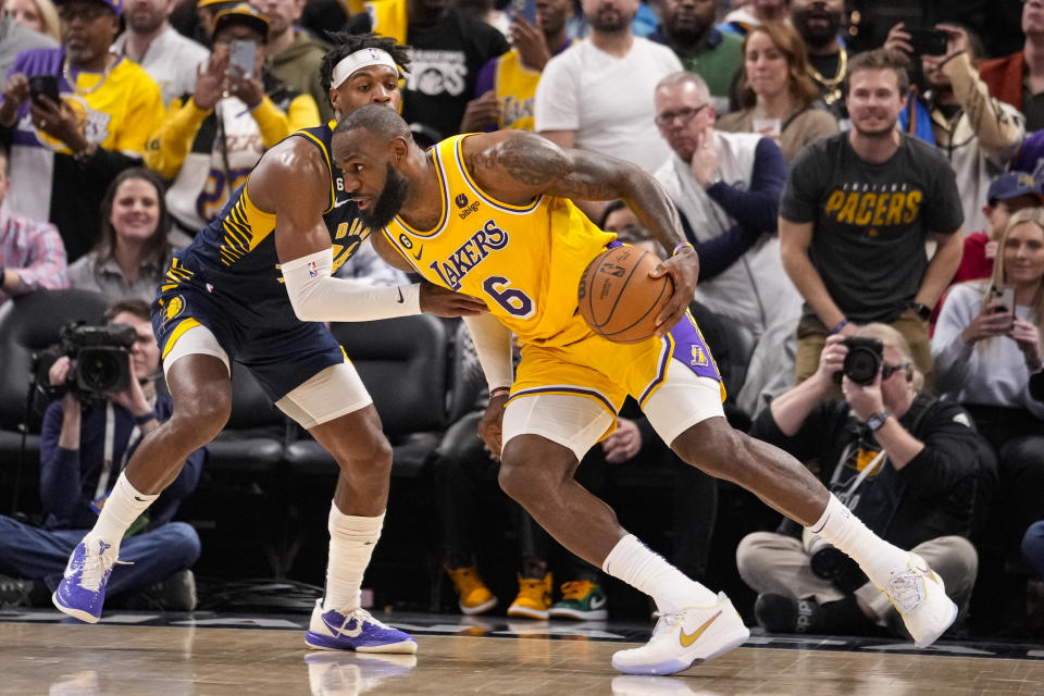 Los Angeles Lakers forward LeBron James (6) drives on Indiana Pacers guard Buddy Hield (24) during the second half of an NBA basketball game in Indianapolis, Thursday, Feb. 2, 2023. The Lakers defeated the Pacers 112-111. (AP Photo/Michael Conroy)