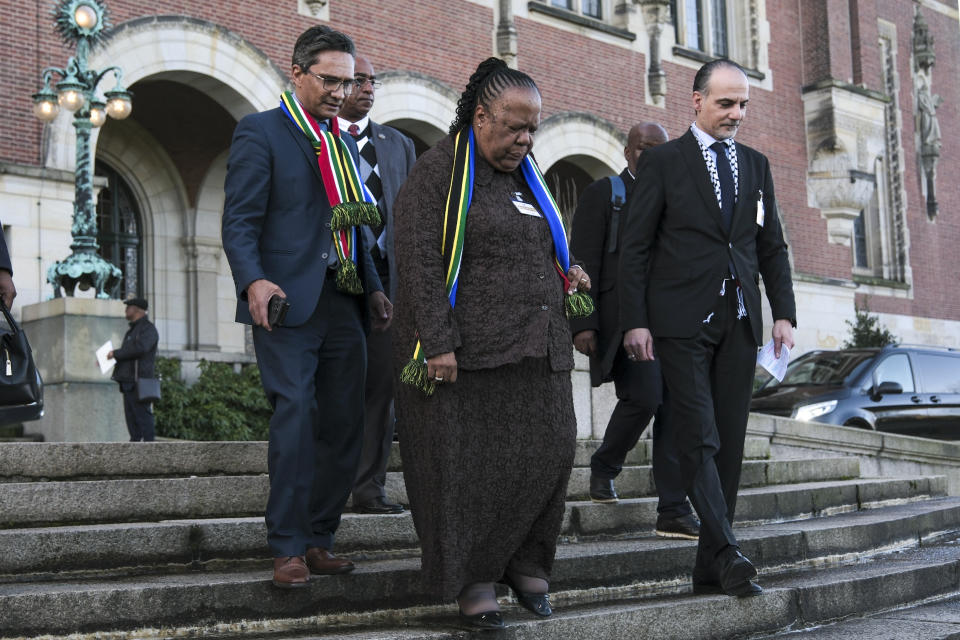 South Africa's Foreign Minister Naledi Pandor, centre, leaves the building after session of the International Court of Justice, or World Court, in The Hague, Netherlands, Friday, Jan. 26, 2024. The United Nations' top court has stopped short of ordering a cease-fire in Gaza in a genocide case but demanded that Israel try to contain death and damage in its military offensive in the tiny coastal enclave. South Africa brought the case and had asked the court to order Israel to halt its operation. (AP Photo/Patrick Post)