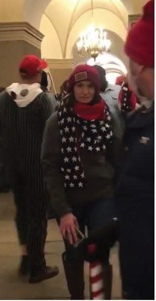 The U.S. Justice Department says this photo of a woman at the Capitol Riot of Jan. 6, 2021, is Anna Lichnowski, formerly of Brick.