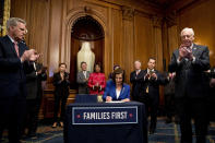 House Speaker Nancy Pelosi of Calif., accompanied by House Minority Leader Kevin McCarthy of Calif., left, House Majority Leader Steny Hoyer of Md., right, and other bipartisan legislators, signs the Coronavirus Aid, Relief, and Economic Security (CARES) Act after it passed in the House on Capitol Hill, Friday, March 27, 2020, in Washington. The $2.2 trillion package will head to head to President Donald Trump for his signature. (AP Photo/Andrew Harnik)