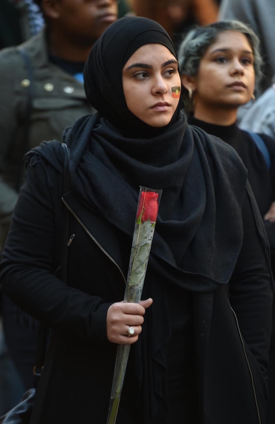 A Muslim woman holds a rose at a Black Lives Matter rally in Sydney on July 16, 2016. Some 300 people gathered at the rally in Sydney to demonstrate against racism in Australia and elsewhere, as racial tensions in the US simmer over the killing of black men by police.