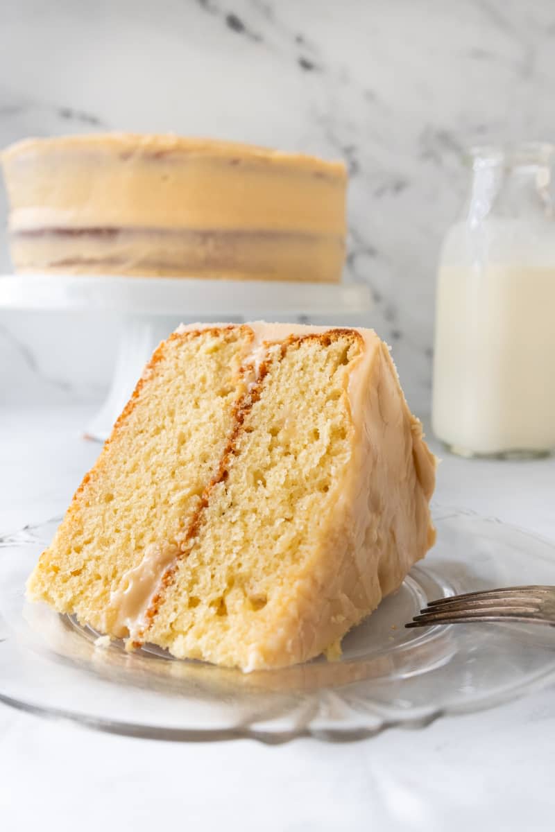 Slice of sour cream cake on plate.