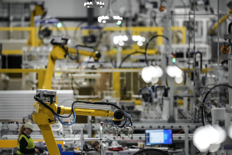 FILE - Articulated robots move inside the Hanwha Qcells Solar plant, Oct. 16, 2023, in Dalton, Ga. On Wednesday, Feb. 28, 2024, the government issues the second of three estimates of GDP growth in the United States during the October-December quarter. (AP Photo/Mike Stewart, File)