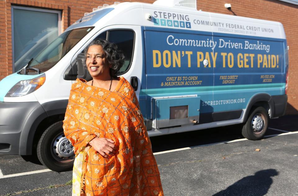 Rashmi Rangan, director of Delaware Community Reinvestment Action Council, with a mini-bus that serves as a remote banking site for people without access to banking.