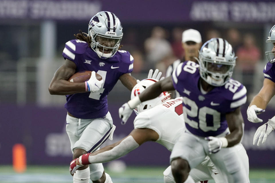 Kansas State wide receiver Malik Knowles (4) attempts to fight of a tackle attempt by Stanford linebacker Levani Damuni, right rear, in the first half of an NCAA college football game in Arlington, Texas, Saturday, Sept. 4, 2021. (AP Photo/Tony Gutierrez)