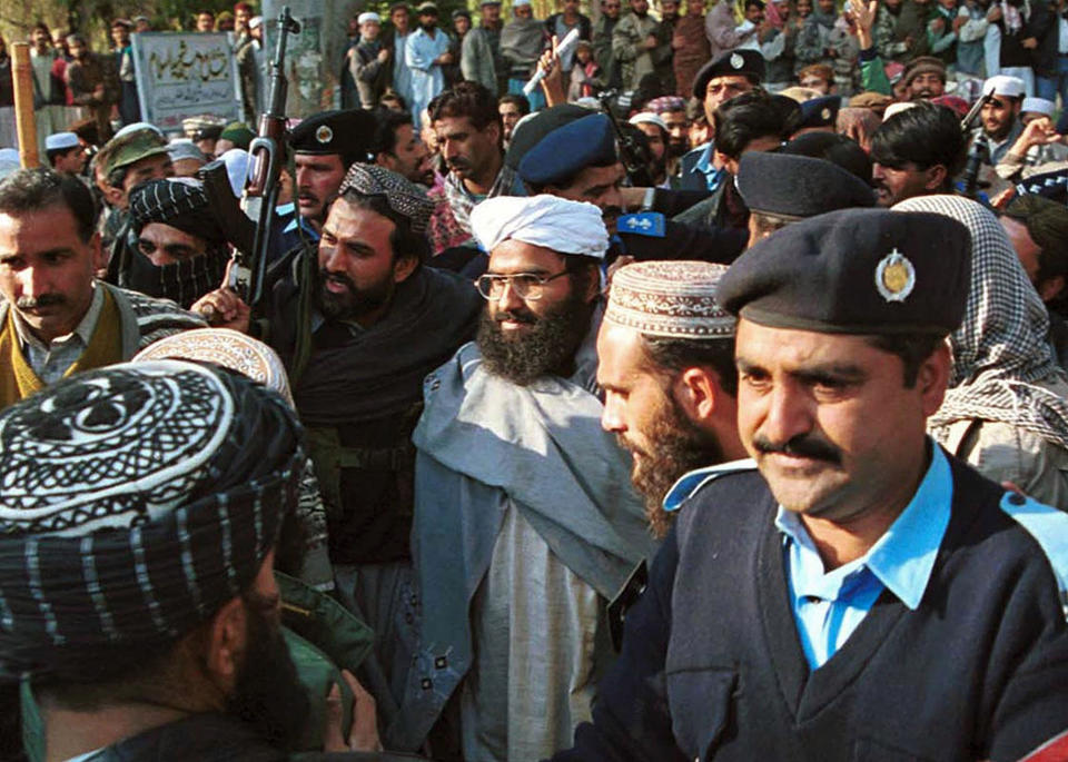 FILE - In this Jan. 27, 2000 file photo, Masood Azhar, center, wearing glasses and white turban, leader of Jaish-e-Mohammad arrives in Islamabad, Pakistan. In 2019, the United Nations added Azhar to its blacklist after several unsuccessful attempts. Pakistan got a mixed review for its efforts to curb terrorist financing and money laundering as it tries to avoid being blacklisted by the Financial Action Task Force, a global watchdog, when it meets in Paris Wednesday, Oct. 16, 2019. (AP Photo/Mian Khursheed, File)