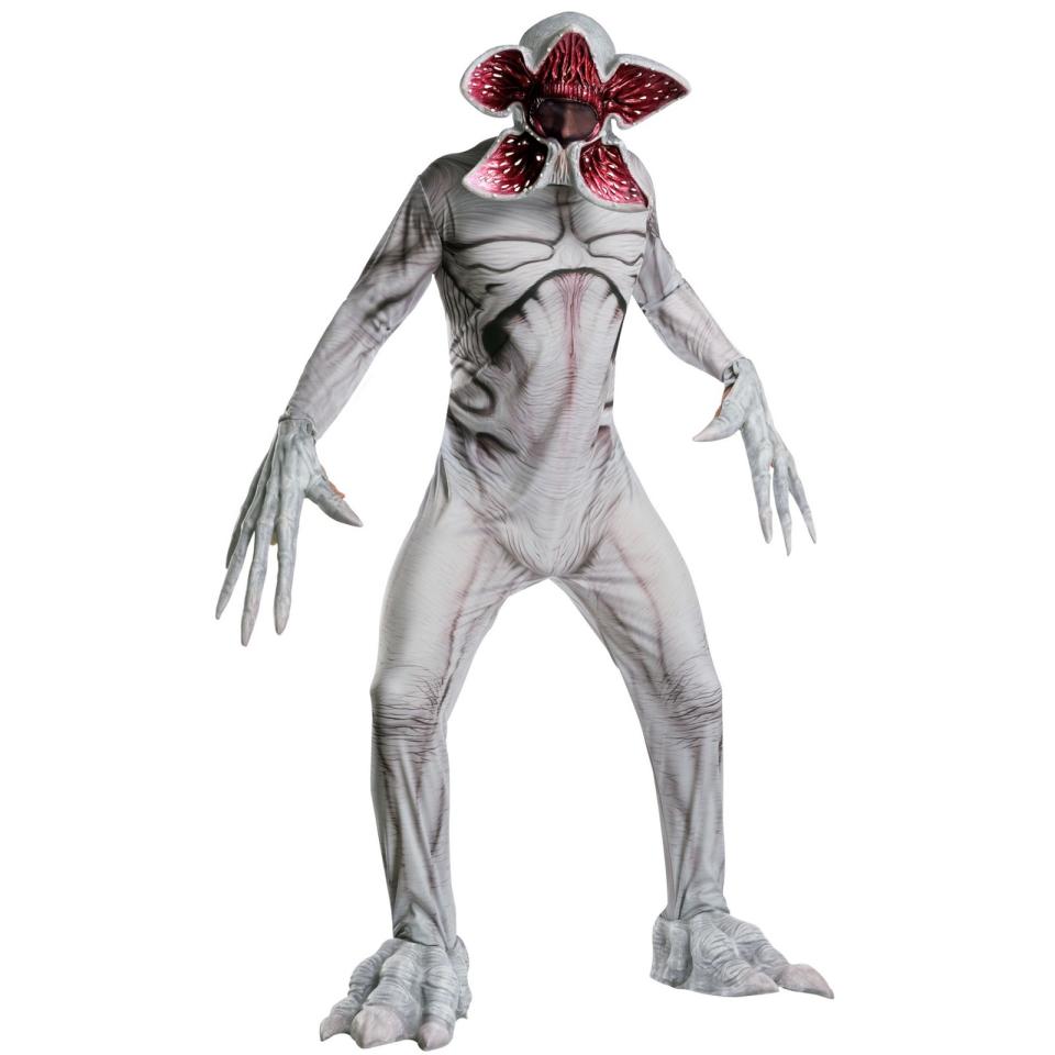a man wearing a demogrogon from stranger things halloween costume on a white background