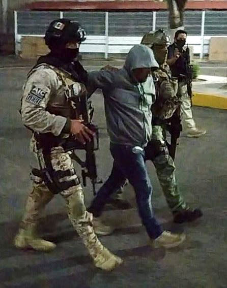 Members of the federal forces escort Jose Antonio Yepez in Guanajuato