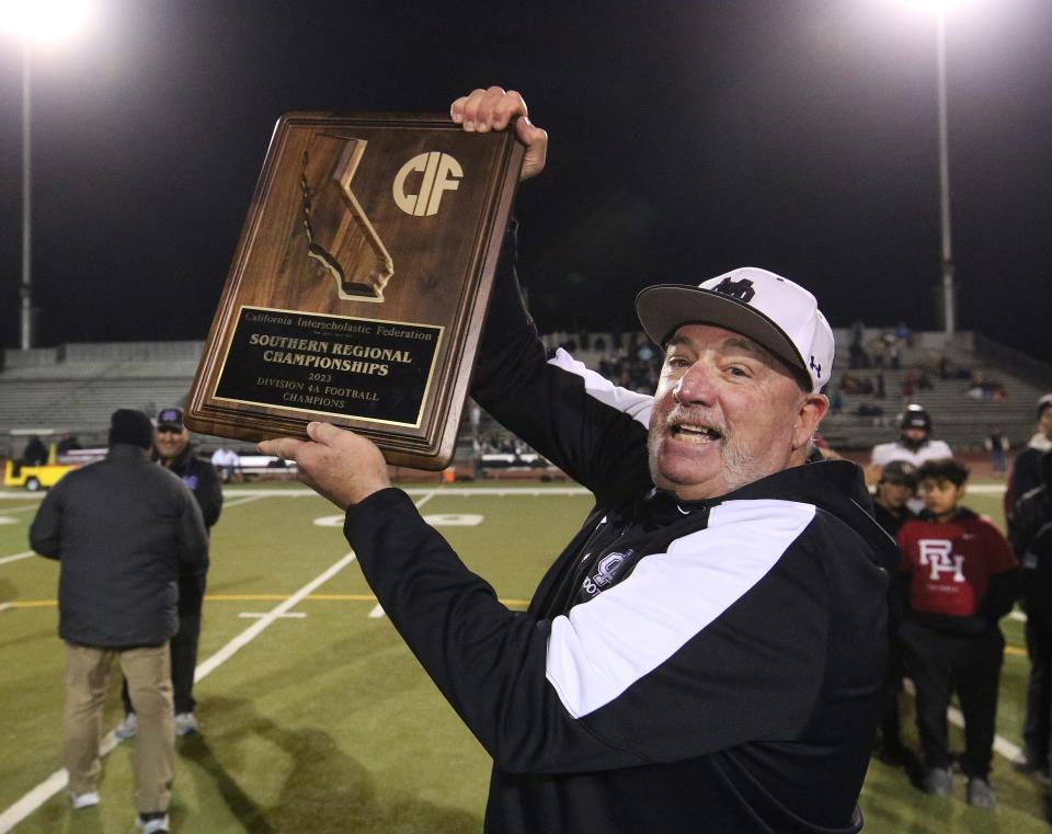 Mission Oak's Head Coach Marty Martin with the championship trophy against Rio Hondo Prep during their CIF State South Division 4-A Football Championship Regional Bowl Game in Tulare, Calif., Saturday, Dec. 2, 2023. Mission Oak won the game 29-14.