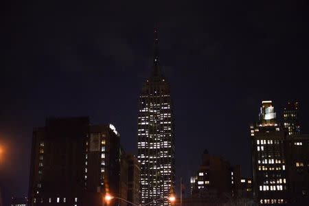 The lights of the Empire State Building are darkened in honor of the victims of the Belgium attacks in Brussels, at the Manhattan borough in New York, March 22, 2016. REUTERS/Stephanie Keith