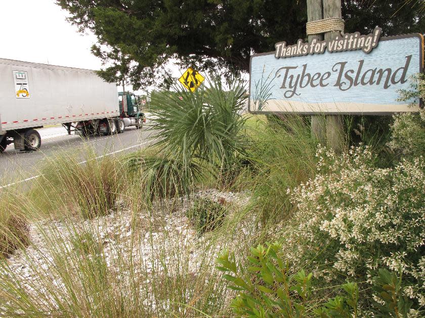 A tractor trailer passes a sign at the city limits of Tybee Island on Wednesday, Nov. 20, 2013. Tybee Island officials have approved installing roadside scanners that read and store license plate information for every car and truck coming and going on the island. The mayor says the city wants the information for a tourism study, but officials are already getting angry calls and emails from residents who say tracking vehicles is too intrusive. (AP Photo/Russ Bynum)