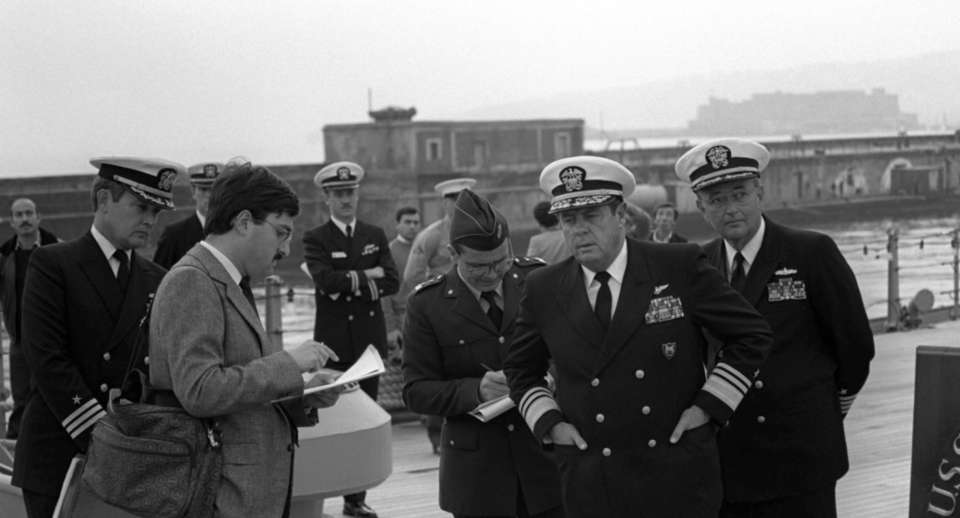 Vice Adm. Kendall E. Moranville (center-right), answers a reporter's question during a press conference for the Italian media aboard the battleship USS Missouri, 1986. <em>National Archives</em>