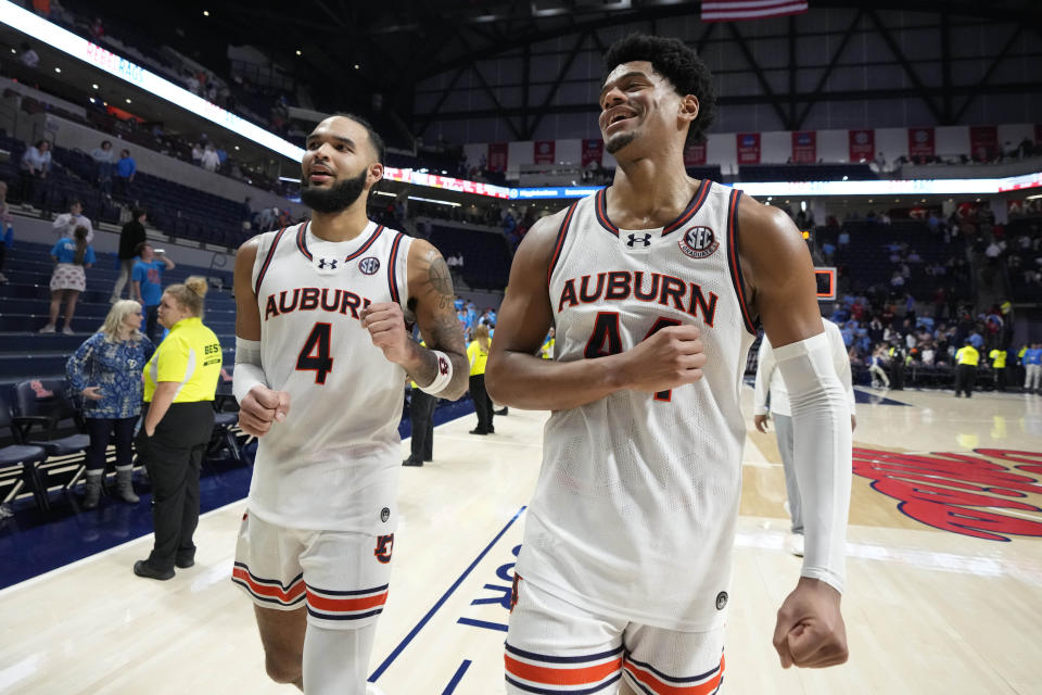 Auburn center Dylan Cardwell (44) and forward Johni Broome (4) celebrate after their win over Mississippi in an NCAA college basketball game, Saturday, Feb. 3, 2024, in Oxford, Miss. (AP Photo/Rogelio V. Solis)