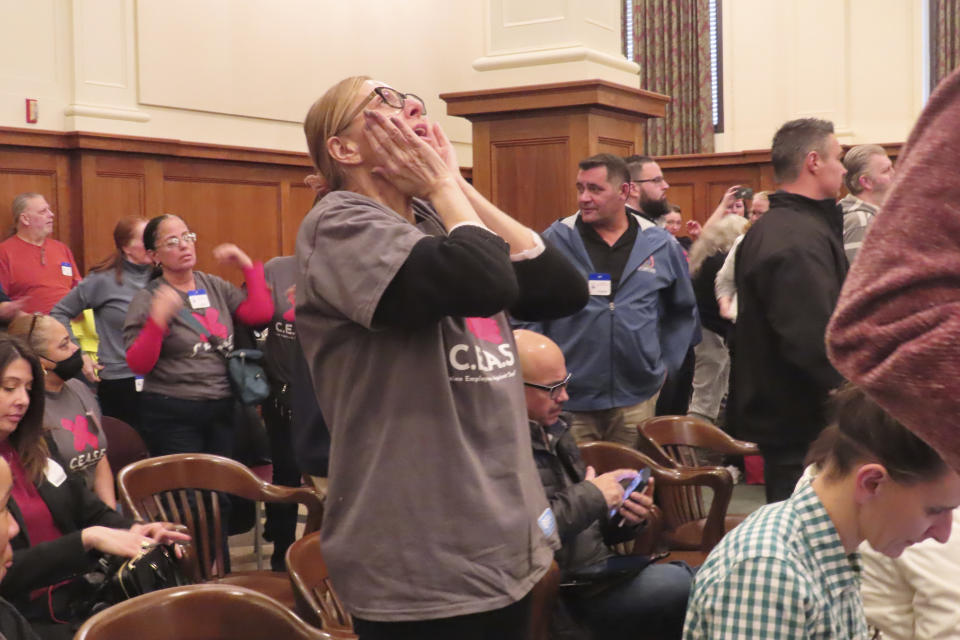 A casino worker exults after a New Jersey Senate committee advanced a bill that would ban smoking in Atlantic City's nine casinos, Monday, Jan. 29, 2024, in Trenton, N.J. The bill still needs numerous additional votes before becoming law. (AP Photo/Wayne Parry)