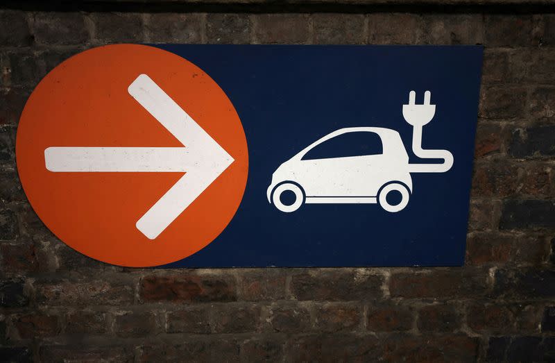 FILE PHOTO: A sign directing towards electric vehicle charging points is seen in a car park in Manchester, Britain