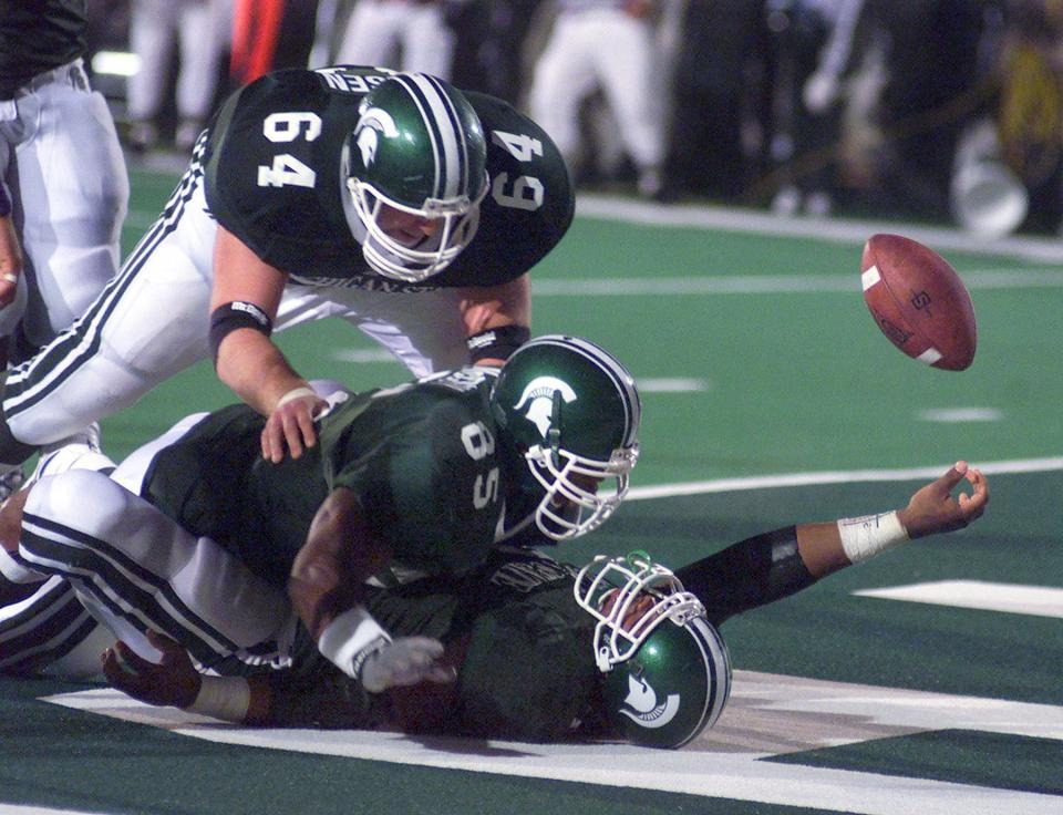 MSU running back T.J. Duckett, bottom, falls into the end zone for the winning touchdown against Penn State, after pulling several Nittany Lions defenders with him, late in the 1999 season.