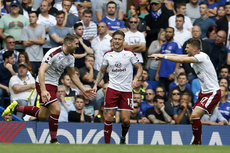 Burnley's Sam Vokes (L) celebrates with teammates, Jeff Hendrick (C) and Johann Berg Gudmundsson, after scoring the opening goal of their English Premier League match against Chelsea, at Stamford Bridge in London, on August 12, 2017