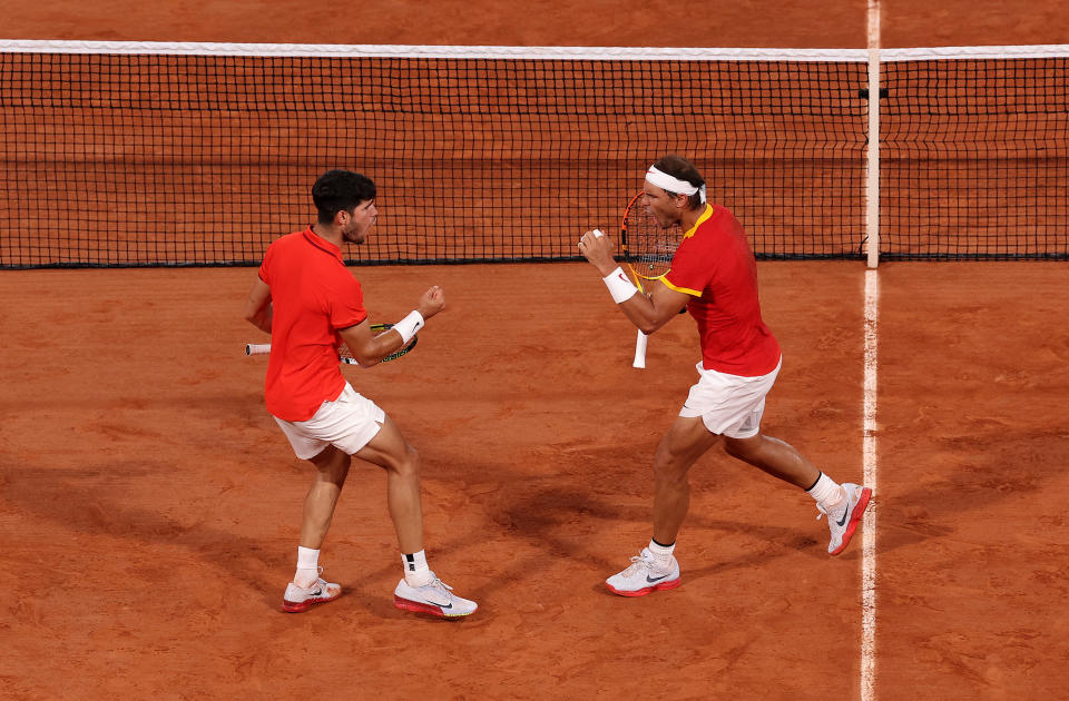 PARIS, FRANCE - JULY 31: Rafael Nadal of Team Spain (R) and Carlos Alcaraz of Team Spain interact against Austin Krajicek of Team United States and Rajeev Ram of Team United States during the Men's Doubles Quarter-final match on day five of the Olympic Games Paris 2024 at Roland Garros on July 31, 2024 in Paris, France. (Photo by Julian Finney/Getty Images)