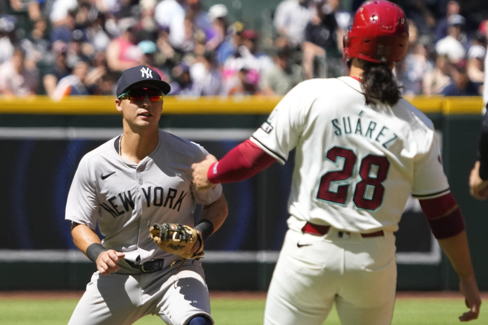 New York Yankees shortstop Anthony Volpe tags out Arizona Diamondbacks' Eugenio Suarez (28) trying to advance to second base in the fourth inning during a baseball game, Wednesday, April 3, 2024, in Phoenix. (AP Photo/Rick Scuteri)