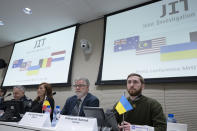 Oleksandr Bannyk, Ukraine, right, Eric van der Sypt, Belgium, second right, Asha Hoe Soo Lian, Malaysia, second left, and David McLean, Australia, are seen during the Joint Investigation Team (JIT) news conference in The Hague, Netherlands, Wednesday, Feb. 8, 2023, on the results of the ongoing investigation into other parties involved in the downing of flight MH17 on 17 July 2014. The JIT investigated the crew of the Buk-TELAR, a Russian made rocket launcher, and those responsible for supplying this Russian weapon system that downed MH17. (AP Photo/Peter Dejong)