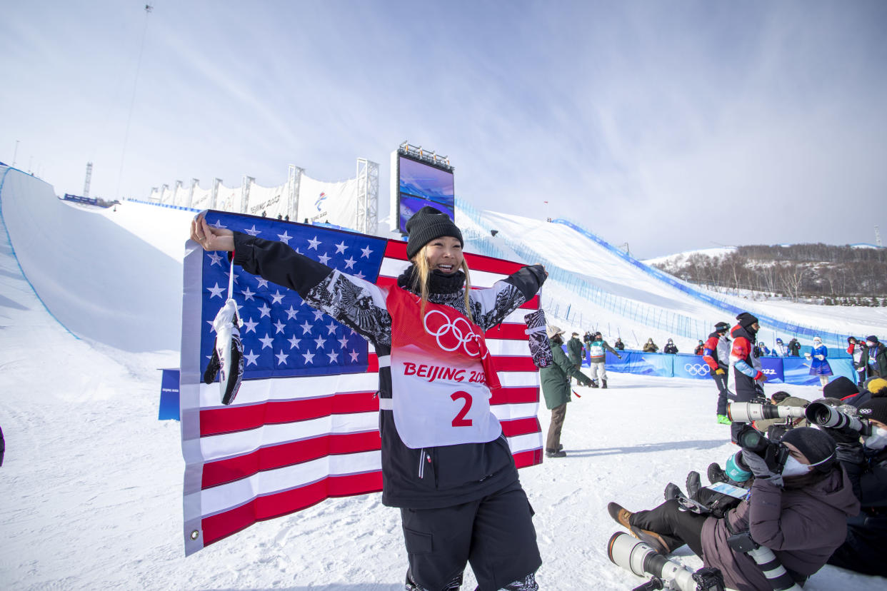 BEIJING, CHINA - February 10:  Chloe Kim of the United States celebrates with the United States flag after winning the gold medal in the Women&#39;s Snowboard Halfpipe Final at Genting Snow Park during the Winter Olympic Games on February 10th, 2022 in Zhangjiakou, China.  (Photo by Tim Clayton/Corbis via Getty Images)