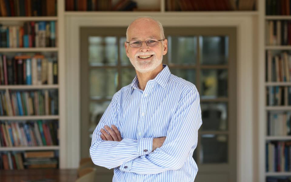 A photo of The Telegraph's tax expert, Mike Warburton, wearing a blue shirt with his arms crossed