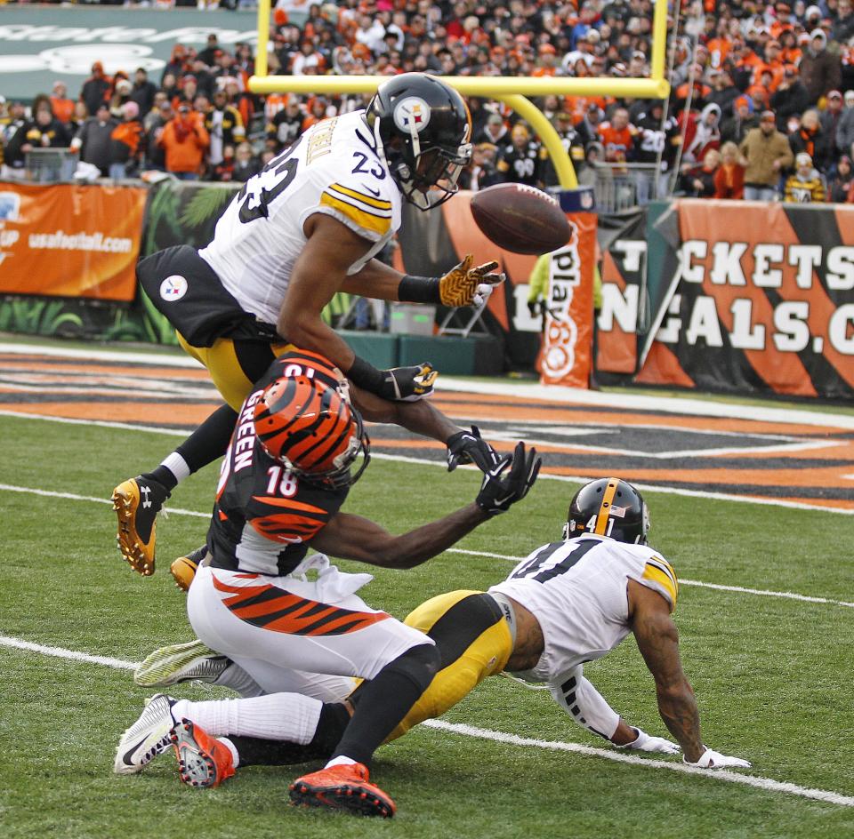 Pittsburgh Steelers free safety Mike Mitchell (23), top, and defensive back Antwon Blake (41) break up a pass intended for Cincinnati Bengals wide receiver A.J. Green (18).