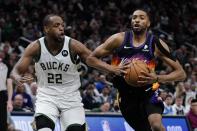 Phoenix Suns' Mikal Bridges drives past Milwaukee Bucks' Khris Middleton during the second half of an NBA basketball game Sunday, March 6, 2022, in Milwaukee. The Bucks won 132-122. (AP Photo/Morry Gash)