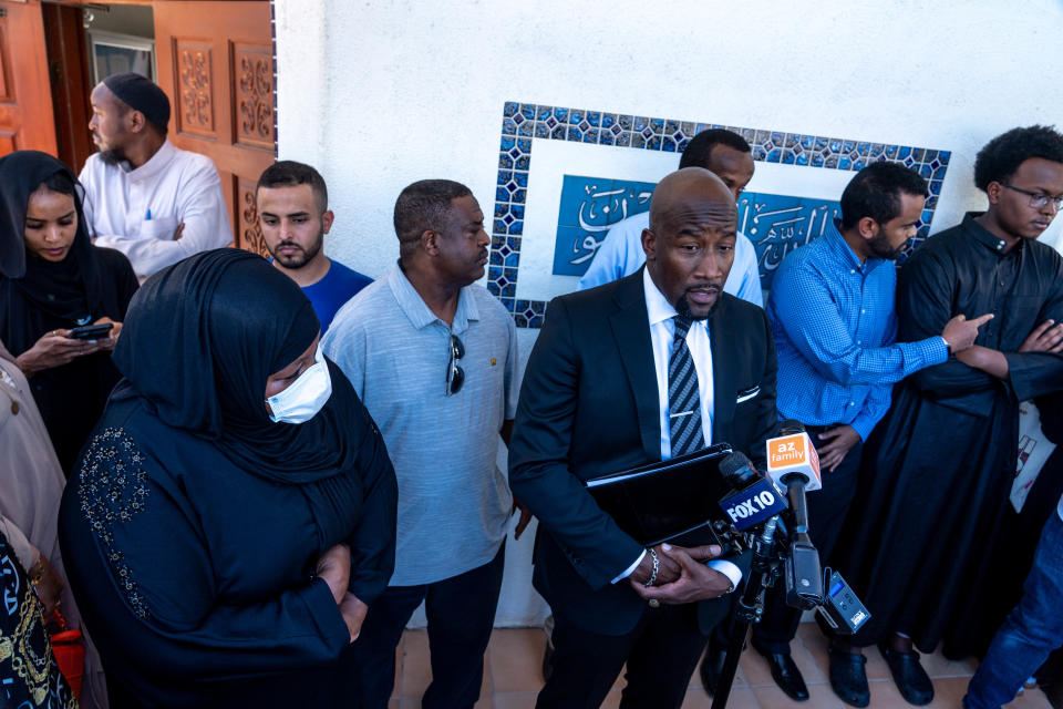 Halima Osman, left, watches as attorney Quacy Smith, front right, speaks during a press conference after a memorial service for her brother Ali Osman, 34, at the Islamic Community Center in Tempe on Sept. 30, 2022. Osman was fatally shot by Phoenix police officers on Sept. 24.