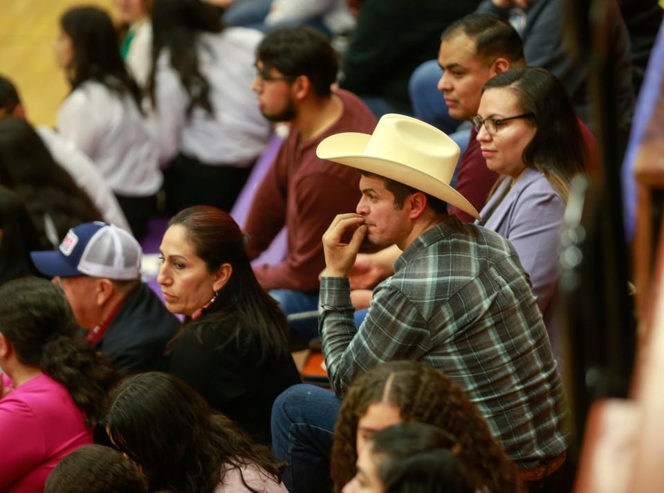 Raul Gutierrez of Denison watches as the Mariachi Reyes del Oeste, Denison High School's top mariachi ensemble, performs during the 2022 Fiesta Mariachi at the Denison High School gymnasium on April 9. The mariachi program has helped unite Denison's white and Latino students, their parents and the broader community.