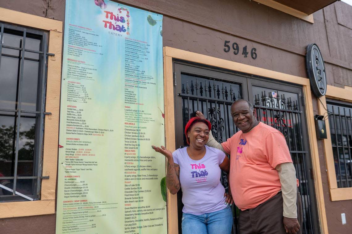 Ashley Frazier and her father, Aaron Frazier, with their extensive menu at This & That Eatery.