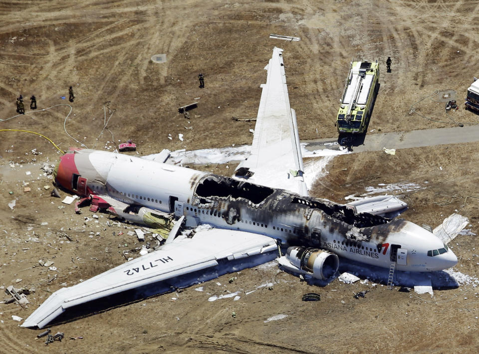 <p> FILE - This Saturday, July 6, 2013 aerial file photo shows the wreckage of the Asiana Flight 214 airplane after it crashed at the San Francisco International Airport in San Francisco. Officials are looking into whether some attorneys may have violated a U.S. law barring uninvited solicitation of air disaster victims in the first 45 days after an accident in connection with the crash landing of Asiana Flight 214 in San Francisco. The National Transportation Safety Board says it has received an unspecified number of complaints about solicitations since the July 6 accident that killed three Chinese teenage girls and injured 180. (AP Photo/Marcio Jose Sanchez)</p>