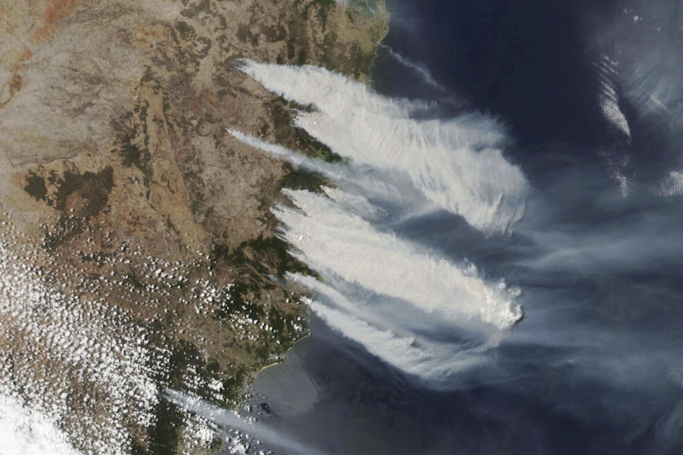 This Nov. 8, 2019, satellite photo taken by NASA shows hot, dry and windy weather conditions as bushfires burn in the eastern part of News South Wales state. Hundreds of schools were closed and residents were urged to evacuate woodlands for the relative safety of city centers Tuesday as hot, dry and windy weather posed an extreme fire danger across the Australia's most populous state. (NASA via AP)