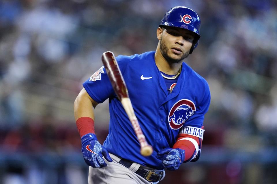 Chicago Cubs' Willson Contreras tosses the bat away after being hit by a pitch against the Arizona Diamondbacks during the fifth inning of a baseball game, Sunday, May 15, 2022, in Phoenix. (AP Photo/Ross D. Franklin)