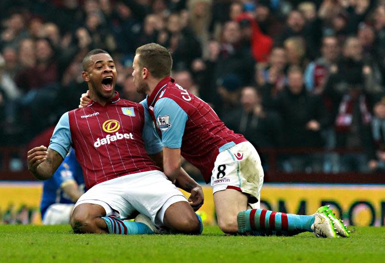 Aston Villa's Leandro Bacuna (L) celebrates scoring a goal with teammate Tom Cleverley during their FA Cup fifth round match against Leicester City at Villa Park in Birmingham, central England, on February 15, 2015