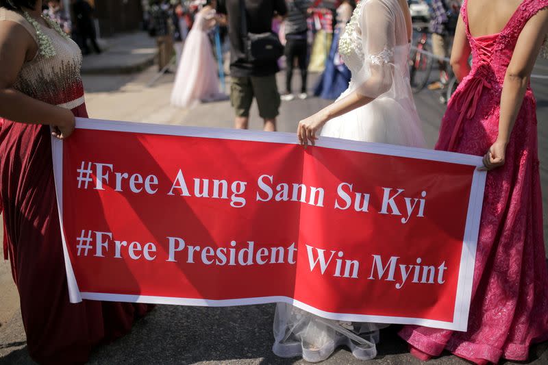 Women wearing ball gowns protest against the military coup in Yangon