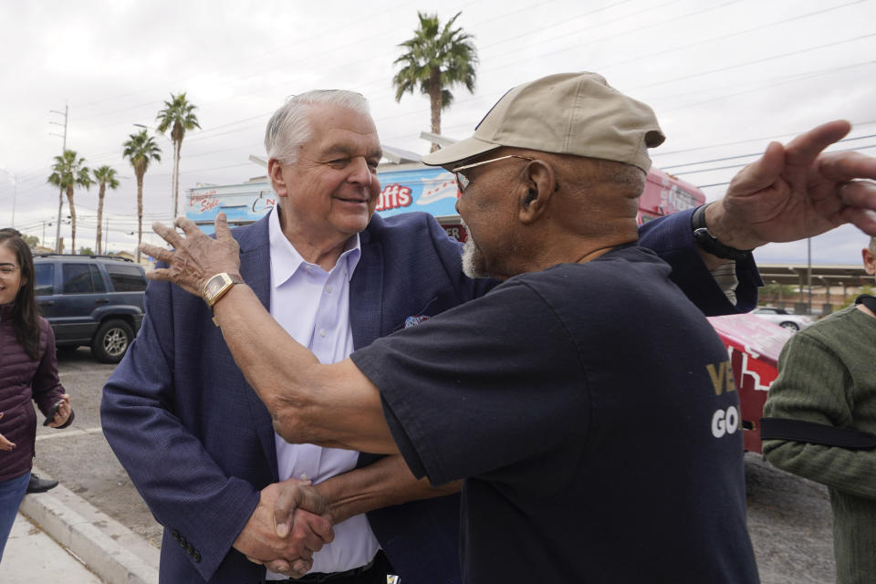 Nevada Gov. Steve Sisolak, left, embraces Willie L. Smith during a campaign event Tuesday, Nov. 8, 2022, in Las Vegas. (AP Photo/Gregory Bull)