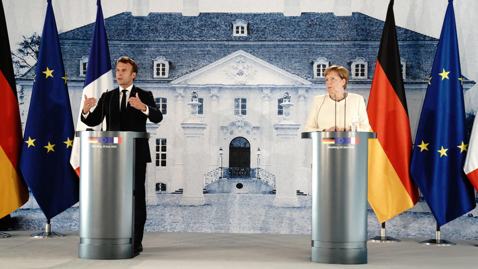 GRANSEE, GERMANY - JUNE 29: German Chancellor Angela Merkel (R) and French President Emmanuel Macron give a press conference after talks in the grounds of Schloss Meseberg on June 29, 2020 in Gransee, Germany. The German Chancellor and French President met to discuss European Union funding during the Coronavirus pandemic. (Photo by Kay Nietfeld - Pool / Getty Images)