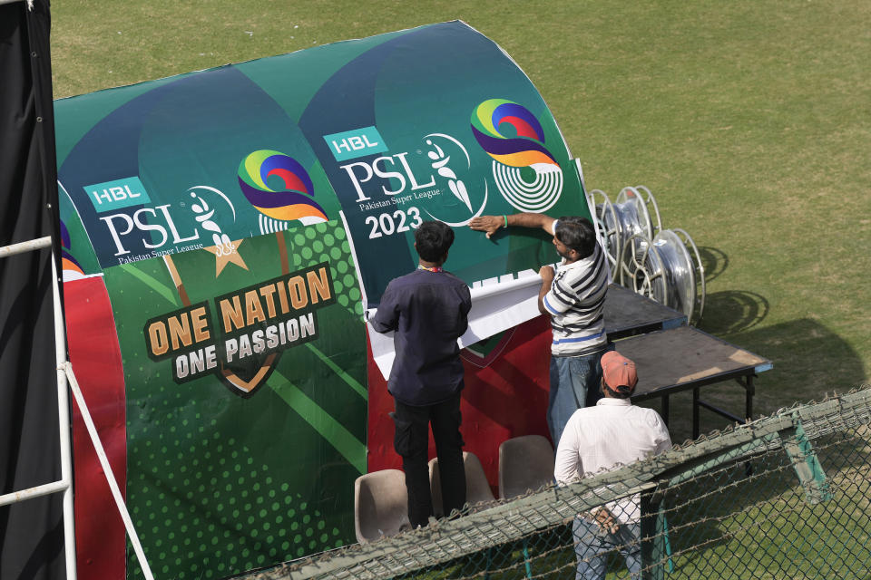Workers decorate an enclosure at the National Stadium in preparation for upcoming Pakistan Super League, in Karachi, Pakistan, Saturday, Feb. 11, 2023. Karachi will host the first leg of nine matches of Pakistan Super League Twenty20 cricket tournament, beginning from Monday. (AP Photo/Fareed Khan)