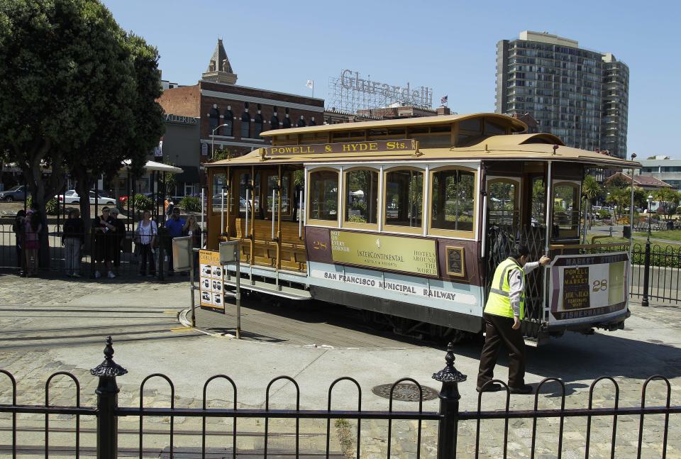 In this photo taken Thursday, May 24, 2012, a Hyde Street cable car is turned around near Fisherman's Wharf and Ghirardelli Square in San Francisco. (AP Photo/Eric Risberg)