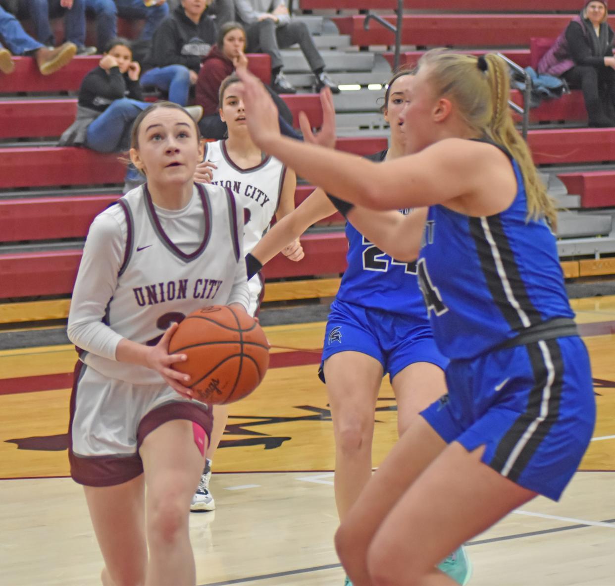 Union City's Addy Rumsey drives hard to the bucket for two while Springport's Hope Overweg defends Thursday night.